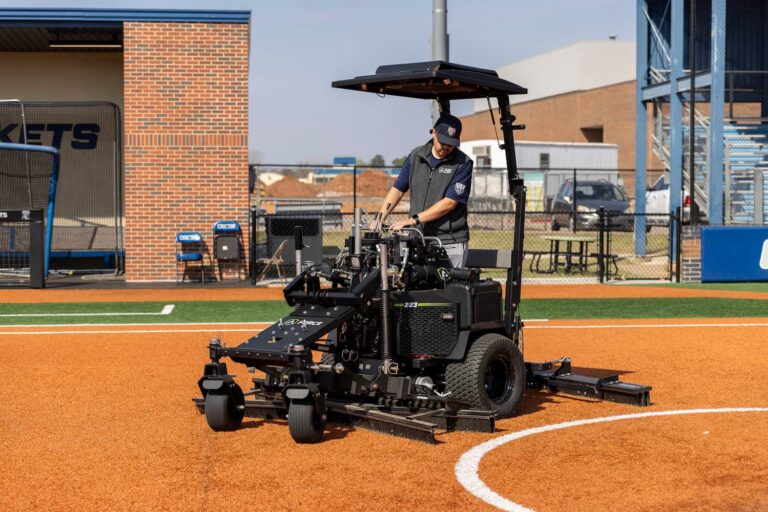 front angle view of an ABI Equipment Force Z-23 for Synthetic Turf being used to groom a softball infield with the POWERVISOR attached